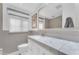 Clean bathroom with marble countertop, white cabinets, and a large mirror at 2727 N 20Th Dr, Phoenix, AZ 85009