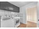 Laundry room with washer, dryer, and shelving at 2727 N 20Th Dr, Phoenix, AZ 85009