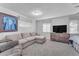 Living area with sectional sofa and mounted TV at 2727 N 20Th Dr, Phoenix, AZ 85009