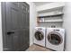 Bright laundry room, featuring washer, dryer, and shelving at 2804 W Curry St, Chandler, AZ 85224