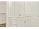 Close up of a bathroom vanity with white cabinets, a large mirror, and modern fixtures at 37013 W La Paz St, Maricopa, AZ 85138