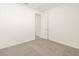 Bright bedroom with neutral carpet and an open doorway at 37013 W La Paz St, Maricopa, AZ 85138