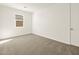 Bright bedroom with plush carpeting and a window providing natural light at 37013 W La Paz St, Maricopa, AZ 85138