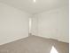 Bright bedroom with carpet flooring and doorway to another room at 37013 W La Paz St, Maricopa, AZ 85138