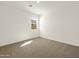 Bright bedroom with carpet flooring and a window at 37013 W La Paz St, Maricopa, AZ 85138