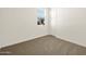 Cozy bedroom with neutral carpet, a window with blinds, and a closet at 37013 W La Paz St, Maricopa, AZ 85138