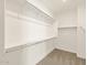 Walk-in closet featuring built-in shelving for organized storage at 37013 W La Paz St, Maricopa, AZ 85138