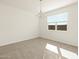 Minimalist dining room with tile floors, a modern chandelier, and a bright window at 37013 W La Paz St, Maricopa, AZ 85138