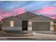Charming single-Gathering home featuring a two-car garage and desert landscaping at 37013 W La Paz St, Maricopa, AZ 85138