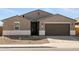 Charming single-Gathering home featuring a two-car garage and desert landscaping at 37013 W La Paz St, Maricopa, AZ 85138