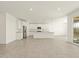 Bright, open kitchen featuring white cabinets and stainless steel appliances at 37013 W La Paz St, Maricopa, AZ 85138