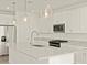 Close up view of the kitchen island with granite counters and stainless steel appliances at 37013 W La Paz St, Maricopa, AZ 85138