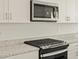 Kitchen with stainless steel microwave and black oven at 37013 W La Paz St, Maricopa, AZ 85138