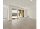 Bright living room with sliding glass doors leading to the backyard at 37013 W La Paz St, Maricopa, AZ 85138