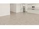 Bright open floor plan with tile flooring, flowing into the kitchen area at 37013 W La Paz St, Maricopa, AZ 85138