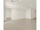 Spacious living room featuring neutral tile flooring and recessed lighting at 37013 W La Paz St, Maricopa, AZ 85138
