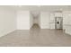 Open-concept living area with tile floors flowing into the kitchen and hallway at 37013 W La Paz St, Maricopa, AZ 85138
