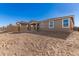 Large backyard with sandy ground and a view of neighboring homes at 40548 W Wade Dr, Maricopa, AZ 85138