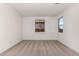 Simple bedroom with neutral carpeting and multiple windows at 40548 W Wade Dr, Maricopa, AZ 85138