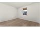 Well-lit bedroom featuring wood-look flooring at 40548 W Wade Dr, Maricopa, AZ 85138