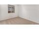 Bright bedroom with carpet flooring and a window at 40548 W Wade Dr, Maricopa, AZ 85138