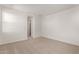 Bright bedroom with carpet flooring and access to hallway at 40548 W Wade Dr, Maricopa, AZ 85138