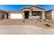 Single-story home with white garage door and stone accents at 40548 W Wade Dr, Maricopa, AZ 85138