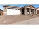 One story home with a white two-car garage and landscaping at 40548 W Wade Dr, Maricopa, AZ 85138