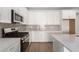 Modern kitchen featuring white cabinets and quartz countertops at 40548 W Wade Dr, Maricopa, AZ 85138