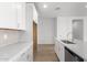 Modern kitchen with white cabinets, quartz countertops and island at 40548 W Wade Dr, Maricopa, AZ 85138