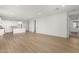 Spacious living room with light wood flooring and access to backyard at 40548 W Wade Dr, Maricopa, AZ 85138