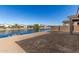 Backyard with a view of a canal and neighboring houses at 40548 W Wade Dr, Maricopa, AZ 85138