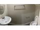 Clean half bathroom featuring a pedestal sink, toilet, and modern fixtures at 1406 W Main St # 140, Mesa, AZ 85201