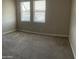 Neutral bedroom featuring plush carpet, two windows for natural light at 1406 W Main St # 140, Mesa, AZ 85201