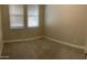 Cozy bedroom with carpeted floors, neutral paint, and two windows providing ample natural light at 1406 W Main St # 140, Mesa, AZ 85201