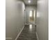 Hallway with wood-style flooring leading to a bedroom with carpet at 1406 W Main St # 140, Mesa, AZ 85201