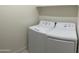 Well-lit laundry room features a white washer and dryer set with a storage shelf above at 1406 W Main St # 140, Mesa, AZ 85201
