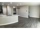Open-concept living space featuring wood-style flooring, a kitchen island, and modern finishes at 1406 W Main St # 140, Mesa, AZ 85201