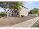 Two-story house with a side yard view and tree at 14171 N 131St Ln, Surprise, AZ 85379