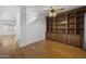 Living room with built-in wooden shelves and hardwood floors at 14171 N 131St Ln, Surprise, AZ 85379