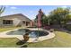 Well-manicured backyard with pool, patio, and umbrella, perfect for outdoor lounging at 14430 N Prickly Pear Ct, Fountain Hills, AZ 85268