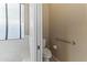 Bright bathroom showcasing a large window above a tub, a toilet, and a safety grab bar at 14430 N Prickly Pear Ct, Fountain Hills, AZ 85268