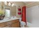 Clean bathroom featuring a vanity, toilet, and shower/tub combination with a red curtain at 14430 N Prickly Pear Ct, Fountain Hills, AZ 85268