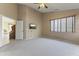 Carpeted bedroom with a ceiling fan, TV and views into the adjacent rooms at 14430 N Prickly Pear Ct, Fountain Hills, AZ 85268