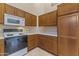 Well-maintained kitchen with wooden cabinets, a microwave, range and tile flooring at 14430 N Prickly Pear Ct, Fountain Hills, AZ 85268