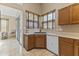 Kitchen featuring wood cabinets, solid surface countertops, tile flooring, and backyard access at 14430 N Prickly Pear Ct, Fountain Hills, AZ 85268