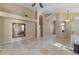 Open living room with tile flooring, neutral tones, arched doorways and a ceiling fan at 14430 N Prickly Pear Ct, Fountain Hills, AZ 85268