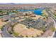 Aerial view of community amenities including lake, pool, clubhouse, and parking at 16731 S 181St Ave, Goodyear, AZ 85338
