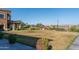 Landscaped lawn area overlooking a lake in Cantamia at 16731 S 181St Ave, Goodyear, AZ 85338