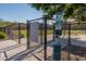 Entrance to the Cantamia dog park with rules and waste disposal at 16731 S 181St Ave, Goodyear, AZ 85338